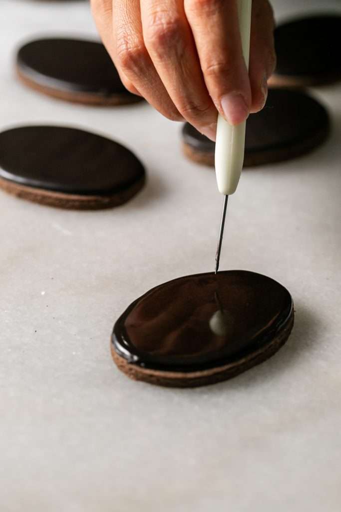 These 3D chocolate sugar cookies are decorated with rich chocolate royal icing and festive Halloween details. Featuring spooky icing transfers, they are not only delicious but perfect for dessert tables. cookie decorating inspiration and halloween themed parties.