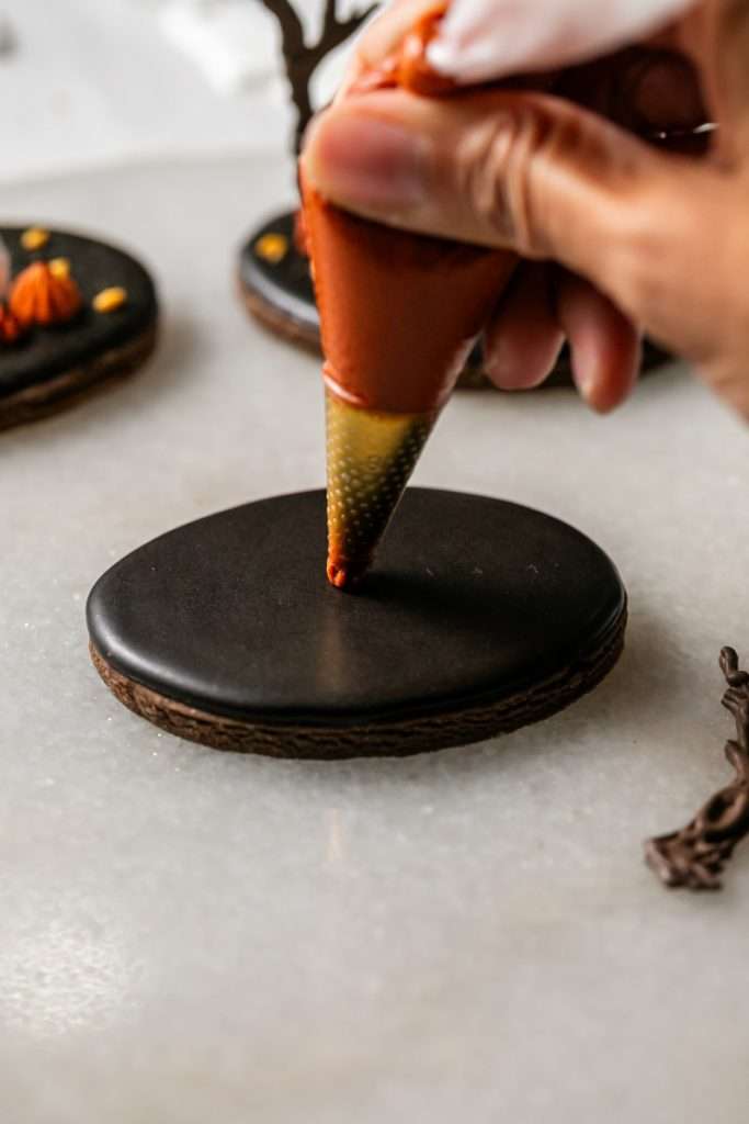 These 3D chocolate sugar cookies are decorated with rich chocolate royal icing and festive Halloween details. Featuring spooky icing transfers, they are not only delicious but perfect for dessert tables. cookie decorating inspiration and halloween themed parties.