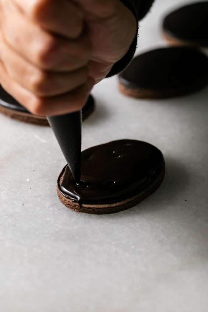 Rich chocolate sugar cookies topped with chocolate royal icing and spooky 3D Halloween details. A festive and delicious treat for the fall season, with step by step decorating instructions.