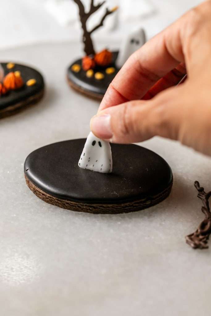 These 3D chocolate sugar cookies are decorated with rich chocolate royal icing and festive Halloween details. Featuring spooky icing transfers, they are not only delicious but perfect for dessert tables. cookie decorating inspiration and halloween themed parties.