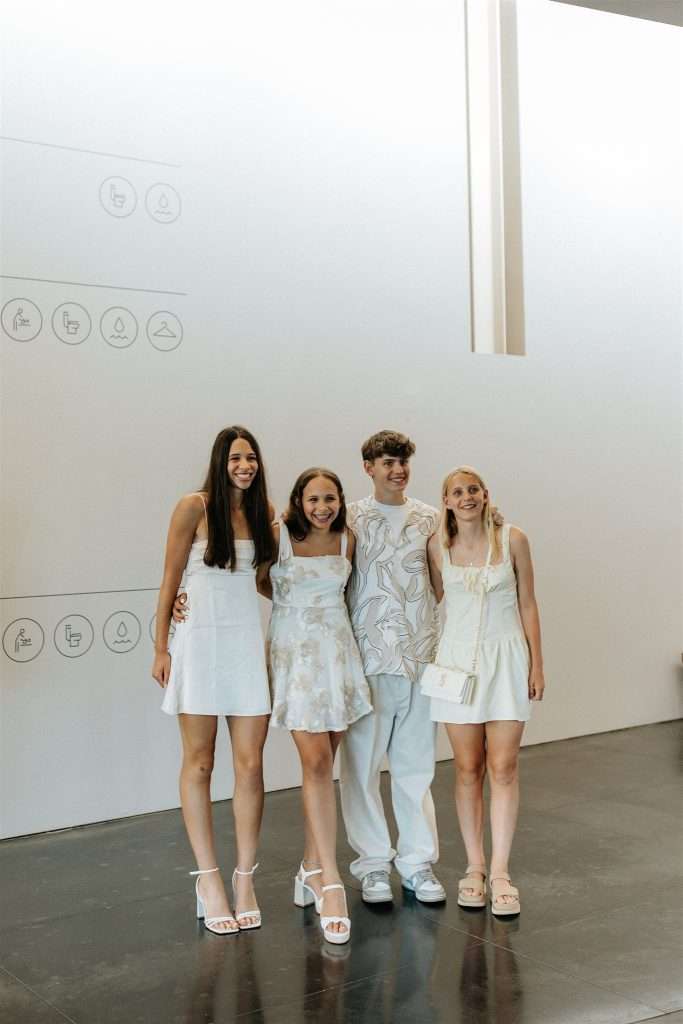 Family gathered at a 20 year wedding anniversary party with black and white decor