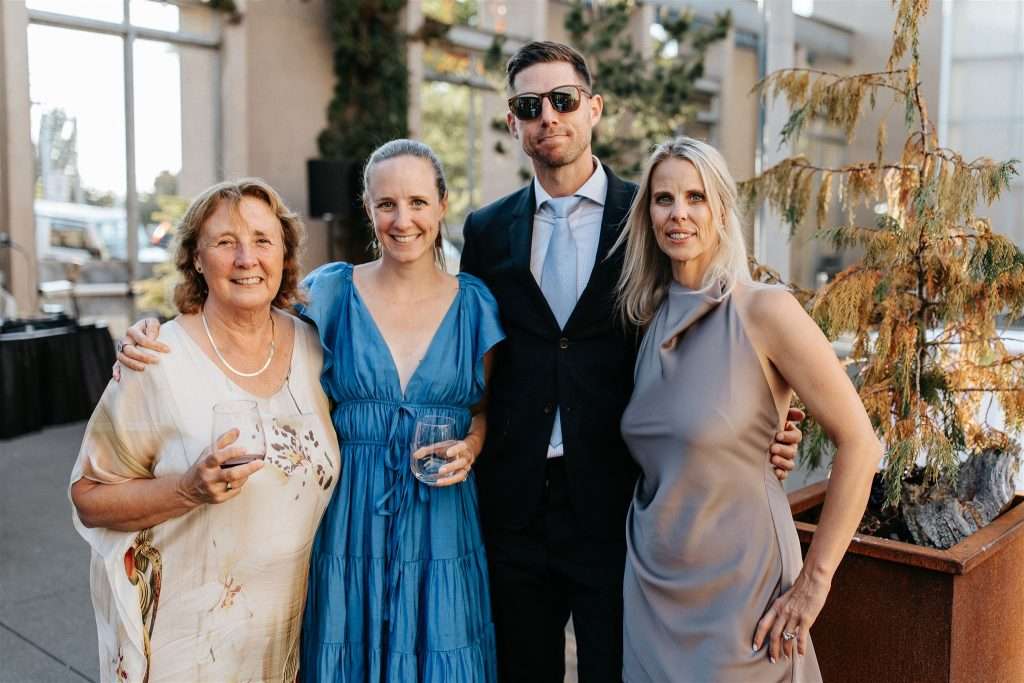 Family gathered at a 20 year wedding anniversary party with black and white decor