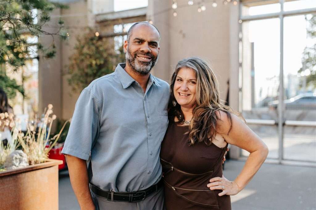 Family gathered at a 20 year wedding anniversary party with black and white decor