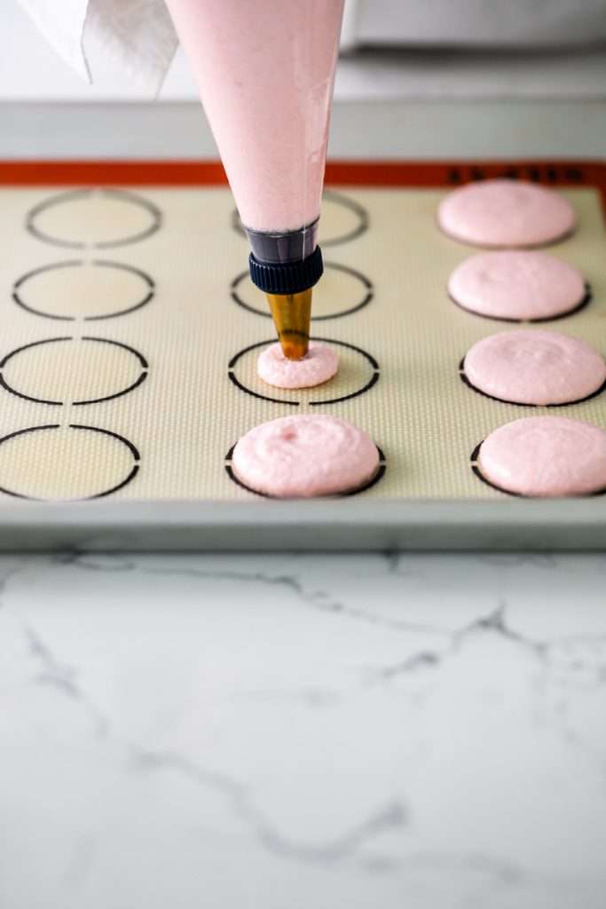 Shirley Temple macarons filled with cherry grenadine gel, and lime buttercream, toped with a glossy cherry.