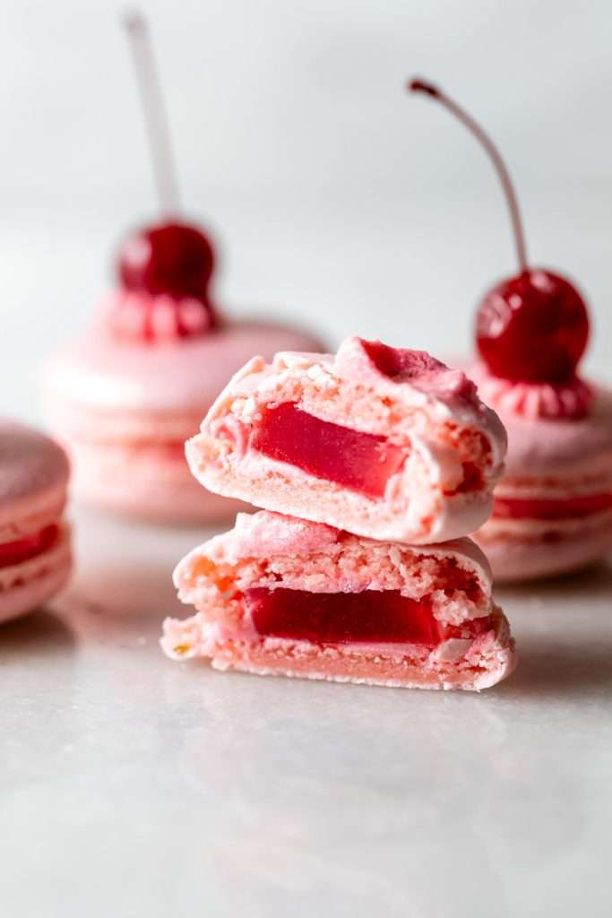 Shirley Temple macarons filled with cherry grenadine gel, and lime buttercream, toped with a glossy cherry.