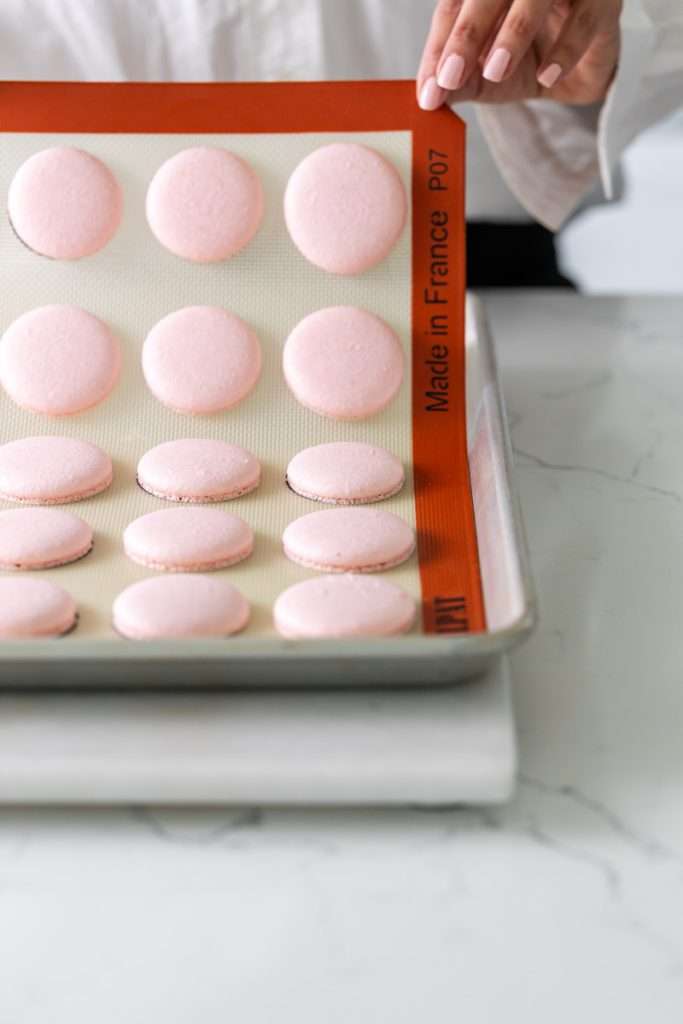 Shirley Temple macarons filled with cherry grenadine gel, and lime buttercream, toped with a glossy cherry.