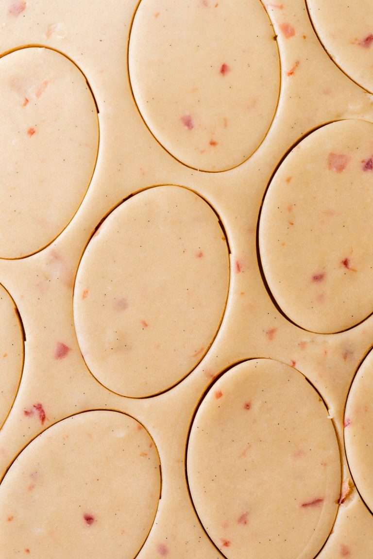 Soft cherry chip cookies with bits of maraschino cherry pieces, freshly bakes and decorated with icing.