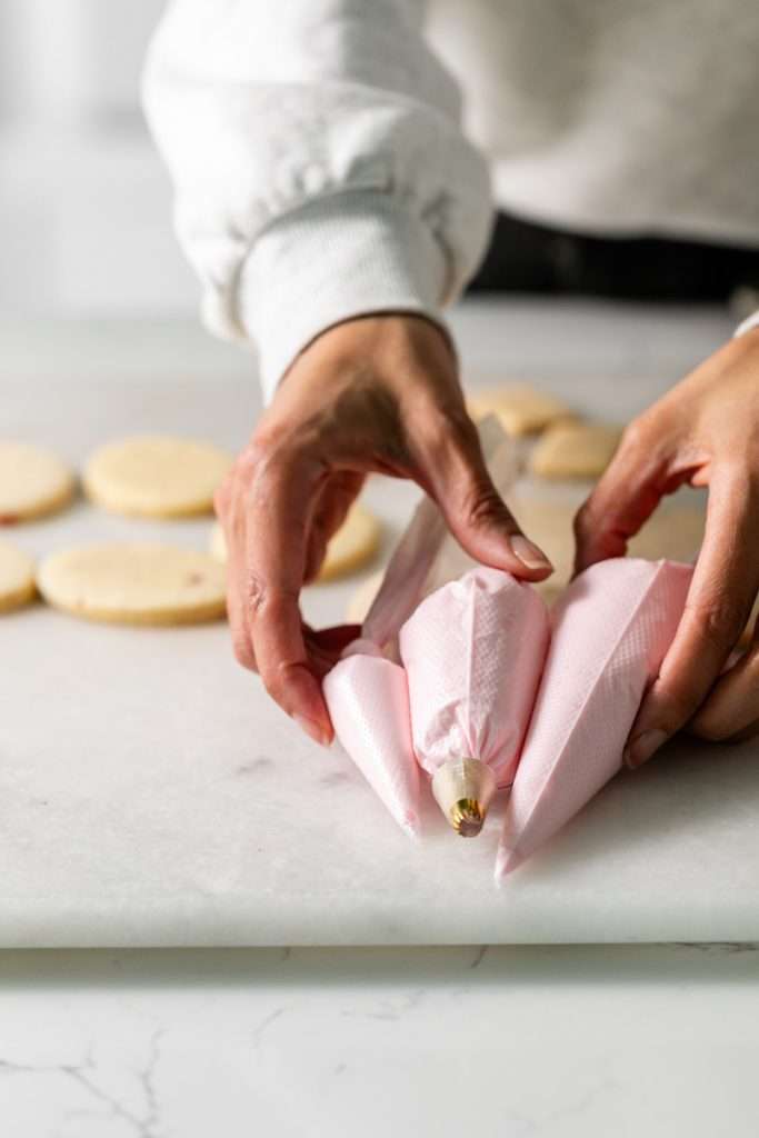 These Cherry Chip sugar cookies are inspired by the classic cherry chip cake! They are soft, buttery and studded with bites of maraschino cherries throughout. Topped with royal icing for a sweet and delicious finish. Perfect for Valentine's Day, birthdays or any festive celebration.