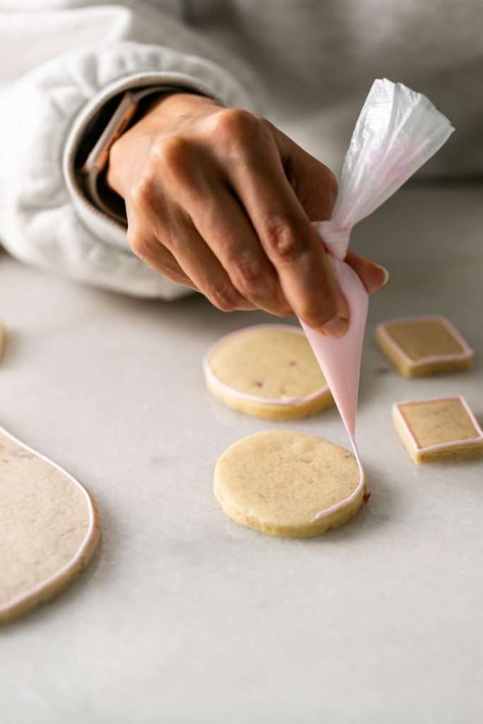 These Cherry Chip sugar cookies are inspired by the classic cherry chip cake! They are soft, buttery and studded with bites of maraschino cherries throughout. Topped with royal icing for a sweet and delicious finish. Perfect for Valentine's Day, birthdays or any festive celebration.