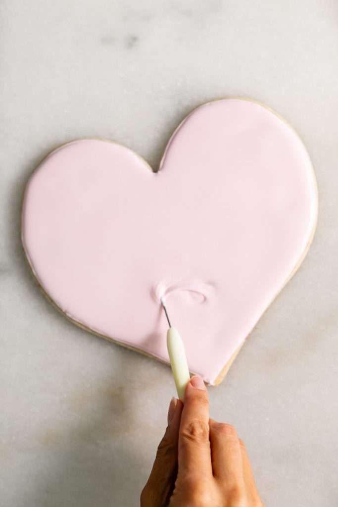 These Cherry Chip sugar cookies are inspired by the classic cherry chip cake! They are soft, buttery and studded with bites of maraschino cherries throughout. Topped with royal icing for a sweet and delicious finish. Perfect for Valentine's Day, birthdays or any festive celebration.