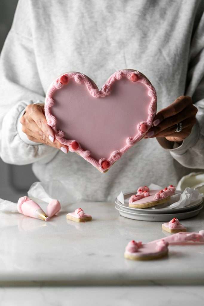 These Cherry Chip sugar cookies are inspired by the classic cherry chip cake! They are soft, buttery and studded with bites of maraschino cherries throughout. Topped with royal icing for a sweet and delicious finish. Perfect for Valentine's Day, birthdays or any festive celebration.