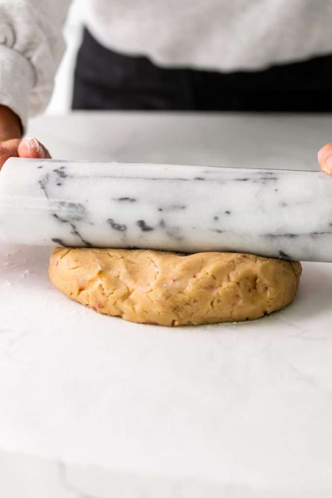 Soft cherry chip cookies with bits of maraschino cherry pieces, freshly bakes and decorated with icing.