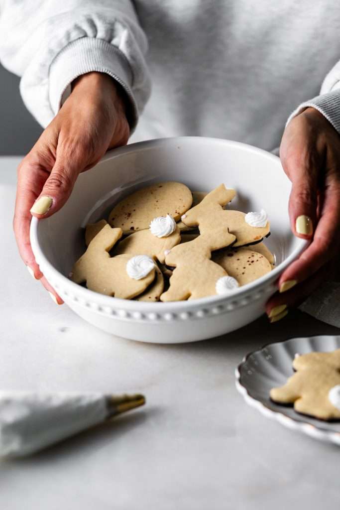 Shaped peanut butter sugar cookies dipped in chocolate and arranged in a serving bowl.