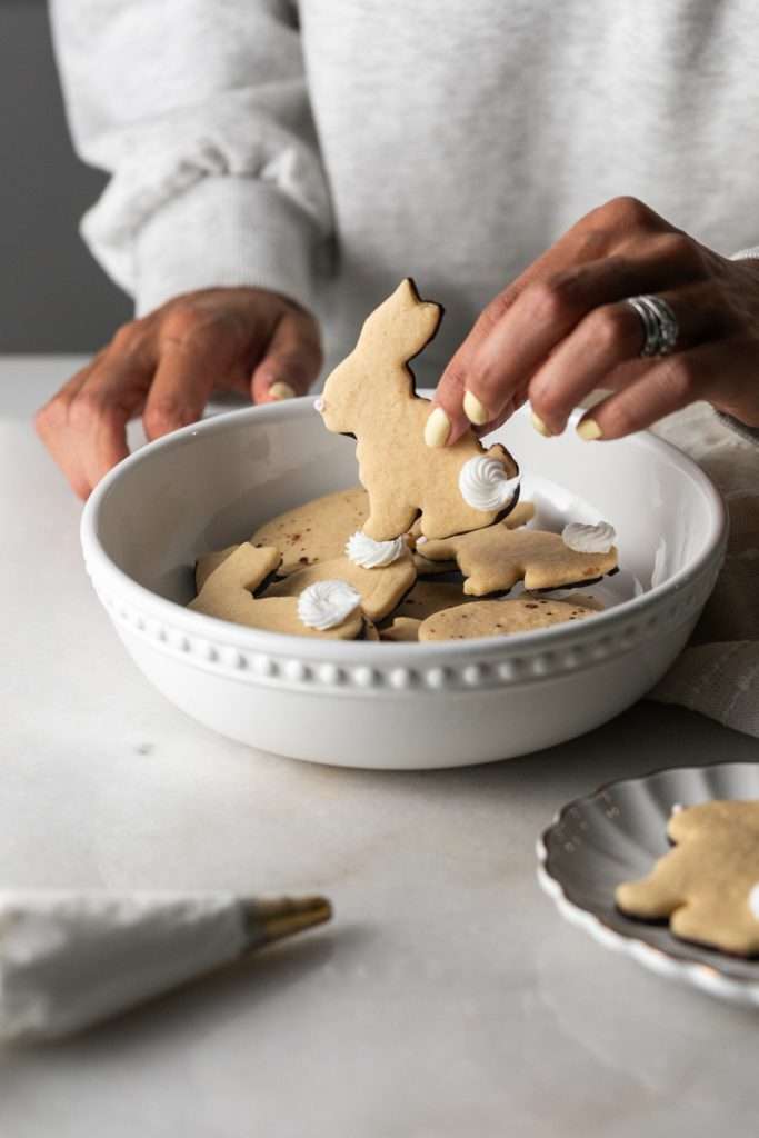 Shaped peanut butter sugar cookies dipped in chocolate and arranged in a serving bowl.