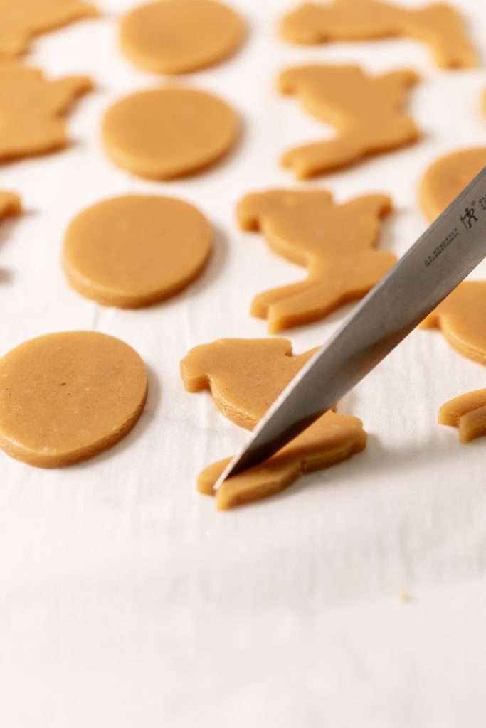 Shaped peanut butter sugar cookies on a sheet of parchment