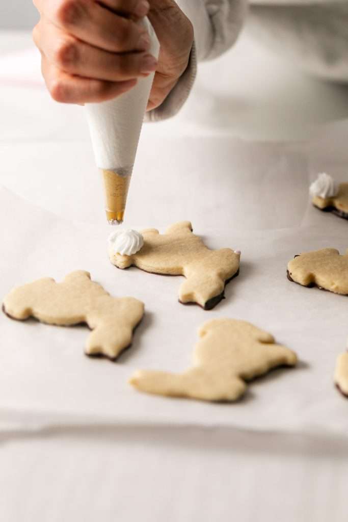 Shaped peanut butter sugar cookies dipped in chocolate and arranged in a serving bowl.