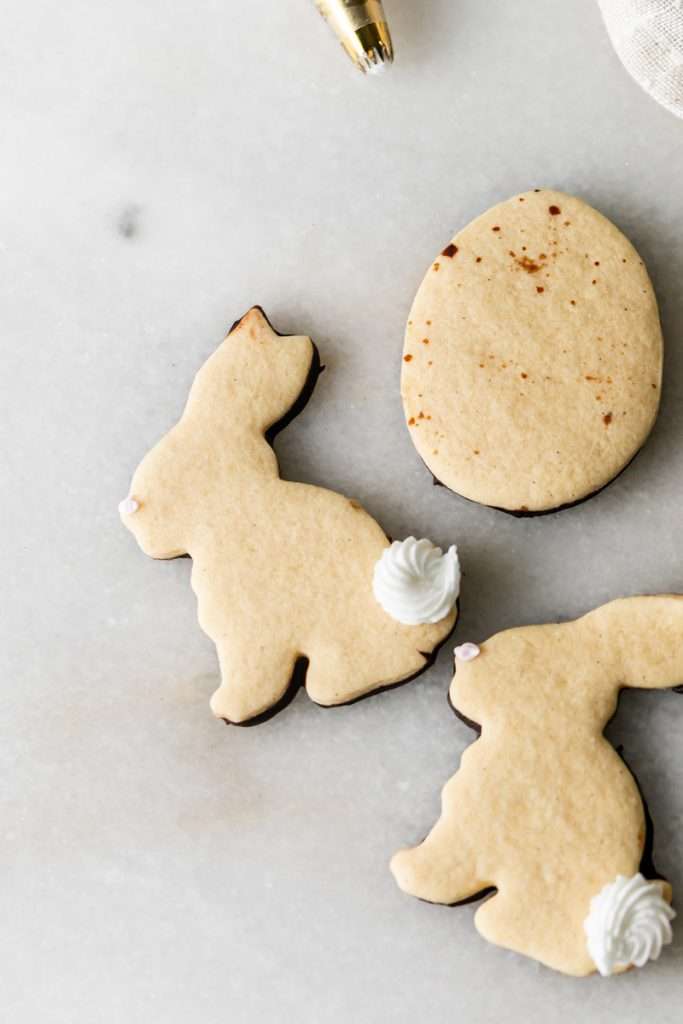 Shaped peanut butter sugar cookies dipped in chocolate and arranged in a serving bowl.