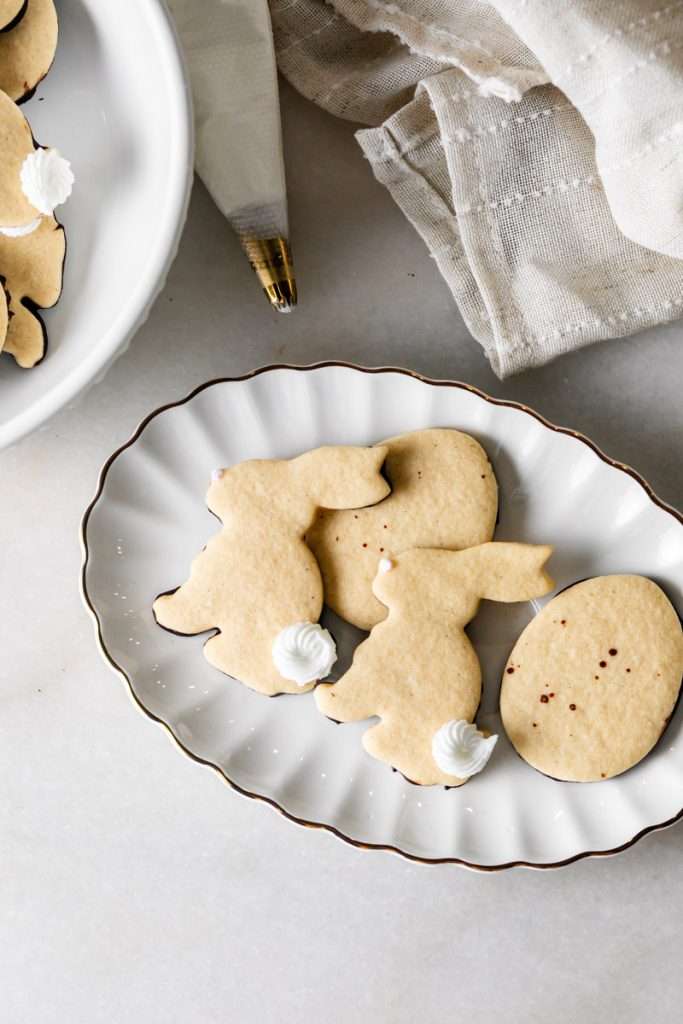 Shaped peanut butter sugar cookies dipped in chocolate and arranged in a serving bowl.