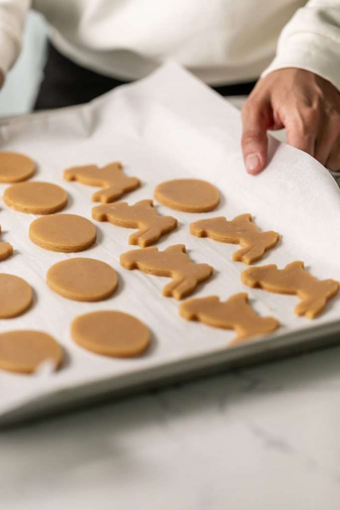 Shaped peanut butter sugar cookies on a sheet of parchment