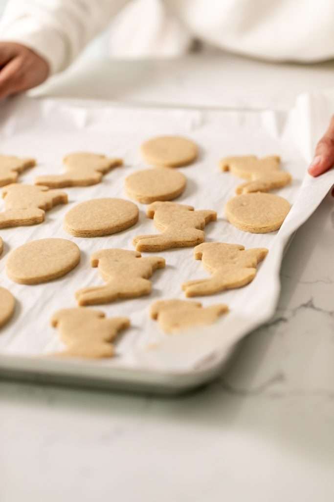 Shaped peanut butter sugar cookies on a sheet of parchment