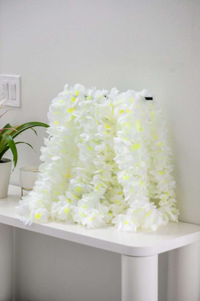 A modern tropical teen birthday party featuring a DIY dirty soda bar, colorful syrups, tropical desserts, and elevated tropical themed party decor in shades of blue and pink.