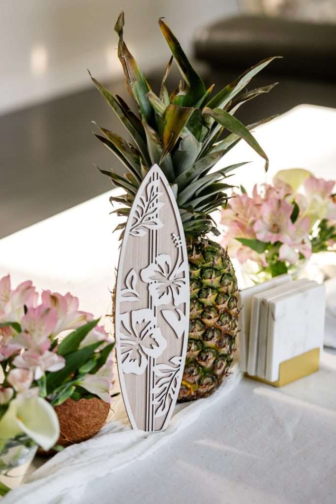 A modern tropical teen birthday party featuring a DIY dirty soda bar, colorful syrups, tropical desserts, and elevated tropical themed party decor in shades of blue and pink.