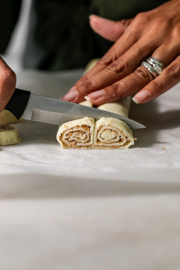 Golden apple cinnamon palmiers made with flaky puff pastry, cinnamon and apple, on a serving plate.
