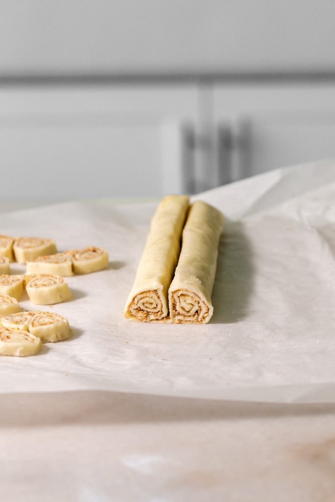 Golden apple cinnamon palmiers made with flaky puff pastry, cinnamon and apple, on a serving plate.